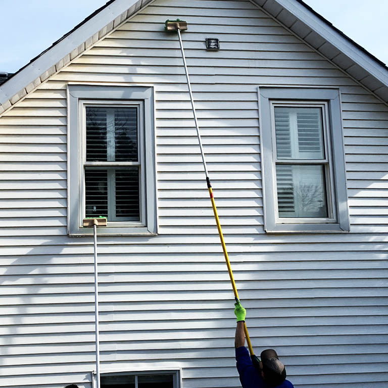 Cleaners washing vinyl siding